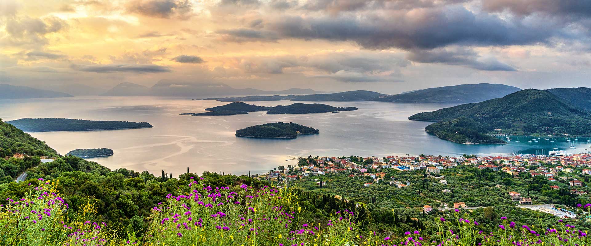 Panoramic view from the top of the hill, overlooking Nydri and the nearby islands of Lefkada. Trust a reputable real estate agent in Lefkada to help you discover your dream property.