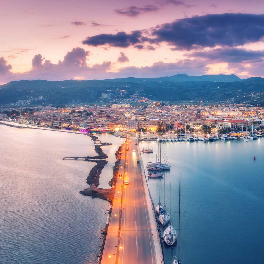 Twilight over Lefkada town, showcasing the marina and waterfront real estate.