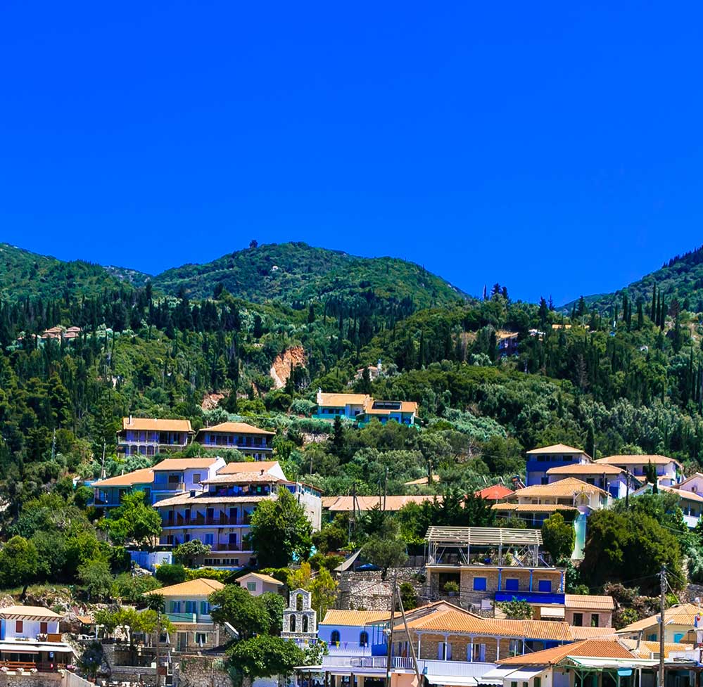 Hillside homes overlooking Agios Nikitas in Lefkada, showcasing attractive real estate.