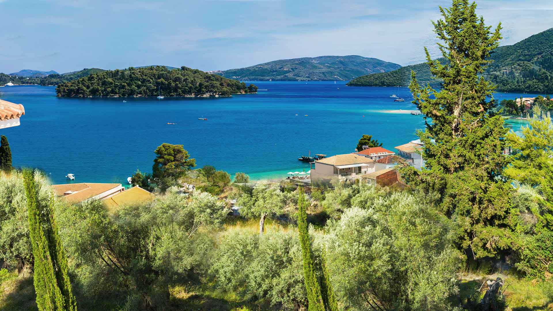 Lush Perigiali coastline with a view of Skorpios Island, highlighting Lefkada's real estate appeal.